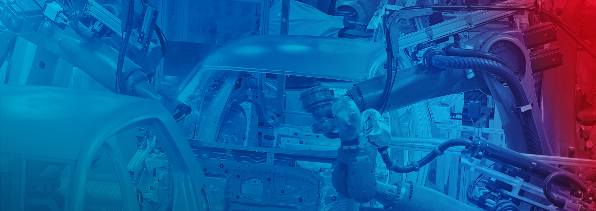 Automated car production: Robots weld a car body.