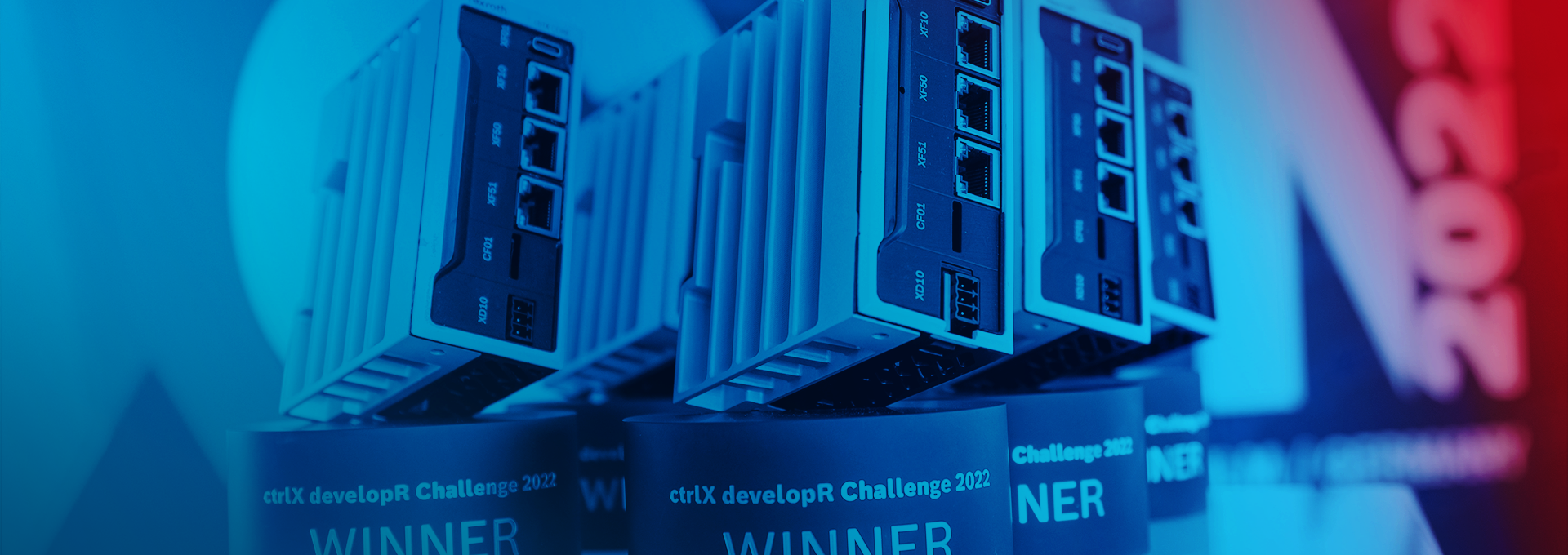 Trophies of the ctrlX developR Challenge in the form of the ctrlX CORE on a pedestal.