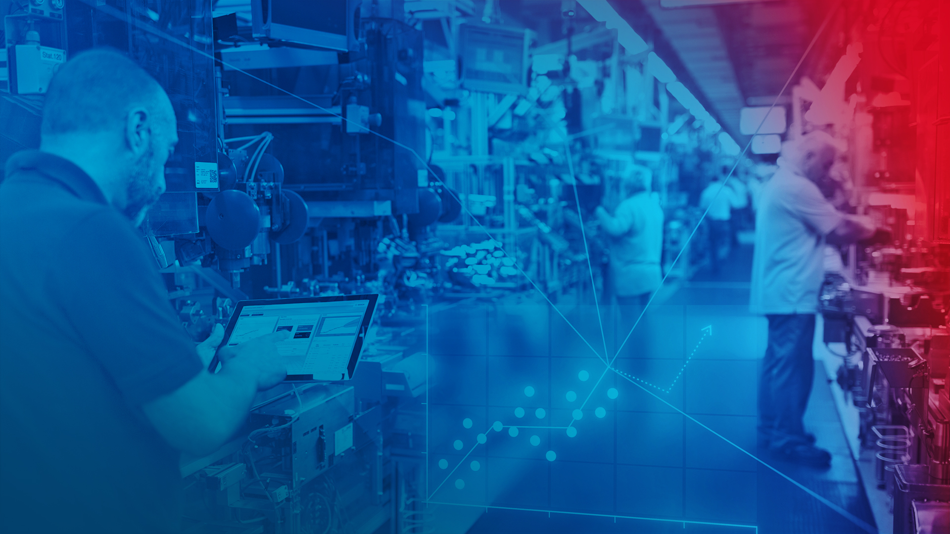 Semi-automated production line with operators. In the foreground, a service technician reads out parameters using his laptop.